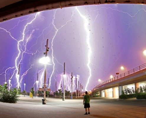 thunder and lightening and a man staring at it